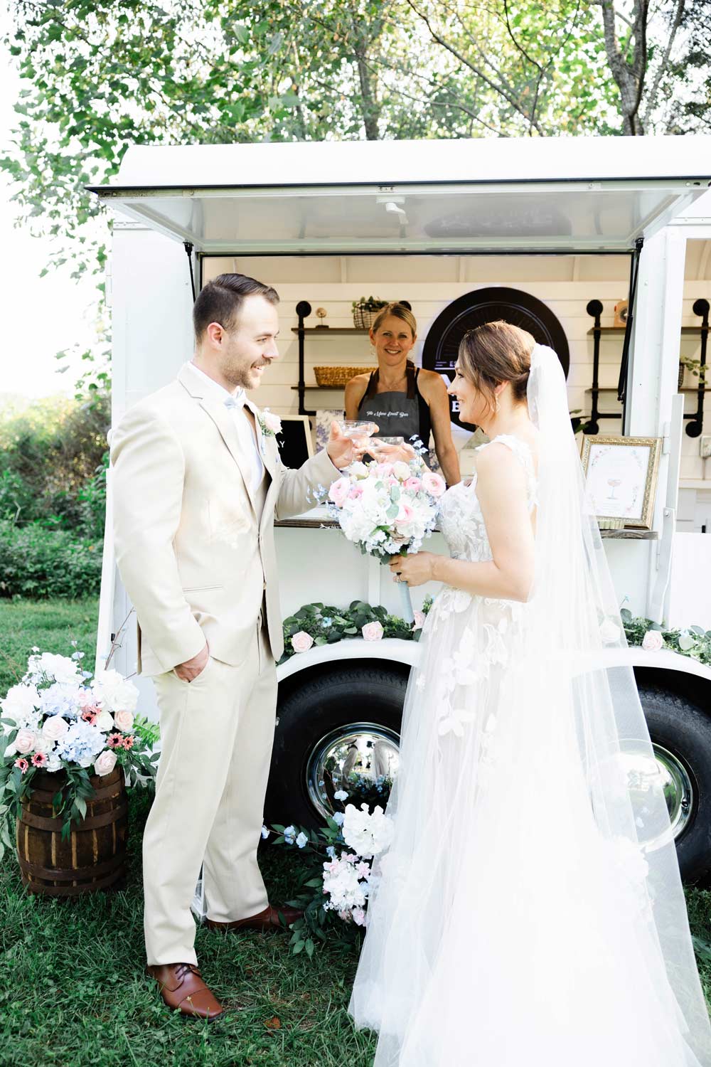 Bride and groom having a signature cocktail in front of the Mane Event Mobile Bar